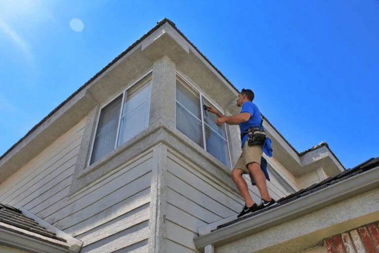 Man Cleaning Windows on Roof