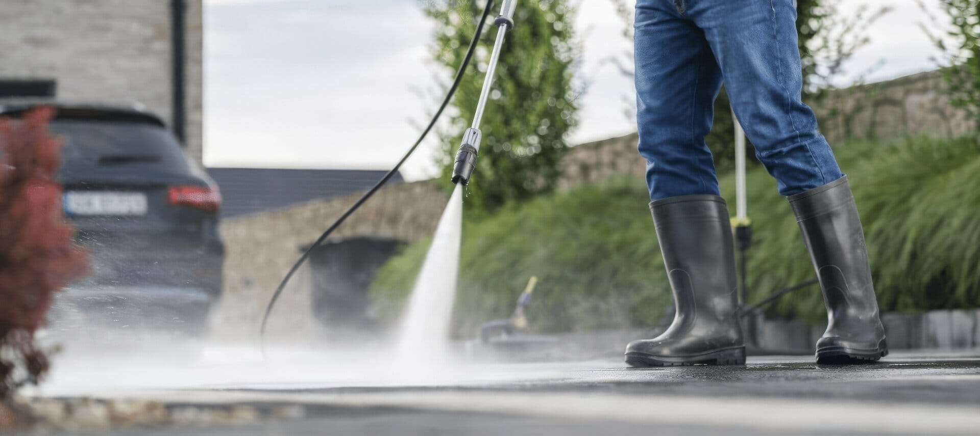 Man Pressure Washing Driveway Wide